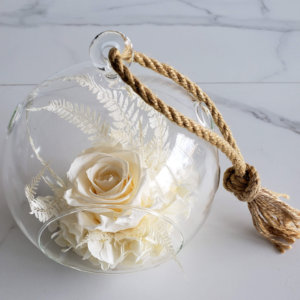 Glass ball with dried flowers.